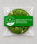 A packaged pistachio, lime, and white chocolate cookie from The Offering Bakehouse, sealed in a clear plastic bag with a green paper label.