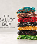 A vertical stack of seven colorful artisan cookies on a light gray surface, with the text 'THE BALLOT BOX' and 'THE GREAT COOKIE ELECTION' printed on the left side.